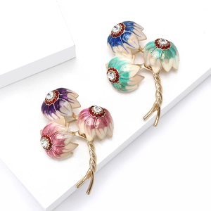Japanese style floral brooch set with enamel finish and crystals on a white display