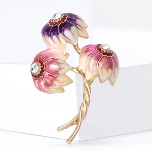 Japanese style enamel flower brooch with crystals and gold base on a white background