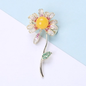 Macro detail of daisy brooch featuring yellow amber resin and micro-pave zircons