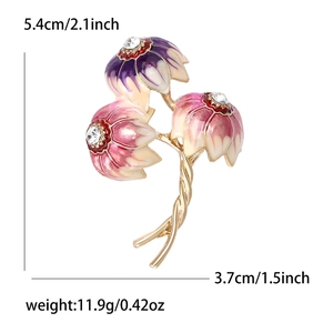 Three-flower brooch with blue and pink gradient petals and gold-tone stems on white background