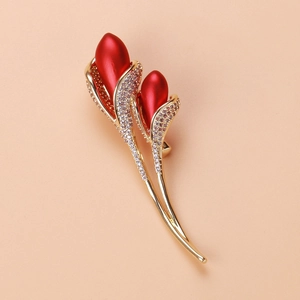 Macro shot of tulip flower brooch with gold plating and sparkling white zircon detailing