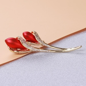 Close-up of elegant tulip brooch with matte red petals and crystal pavé details