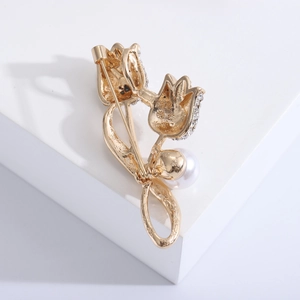 Détail de l'arrière de la broche tulipe dorée avec perles et fermoir sécurisé