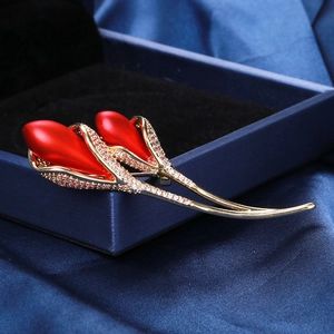 Macro detail of red tulip brooch with gold stem and micro-pave crystal inlay