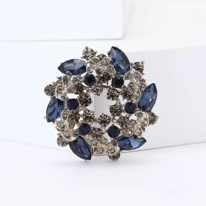Macro detail of high-grade wreath brooch with navy blue and smoky grey crystal rhinestones