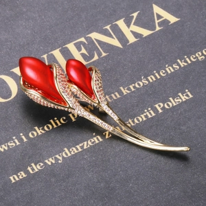 Detailed close-up of a luxury tulip brooch featuring matte red petals and golden zircons