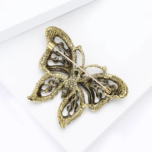 Detailed back view of butterfly brooch with vintage gold finish and secure safety pin