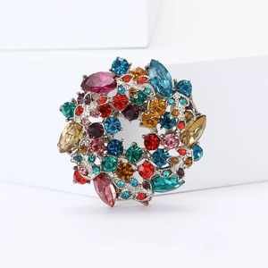 Macro detail of high-end vintage wreath brooch with multi-colored crystals on silver metal