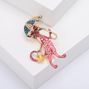 Cute red cat brooch with blue polka dot umbrella and sunglasses on geometric blocks