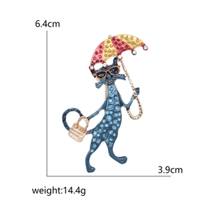 Charming blue cat enamel brooch holding a red and yellow striped umbrella with crystals