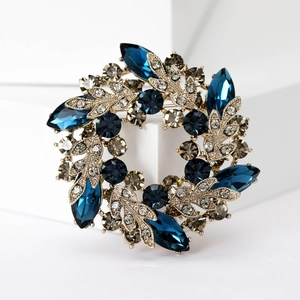 Detailed view of luxury baroque crystal wreath brooch with dark blue marquise stones