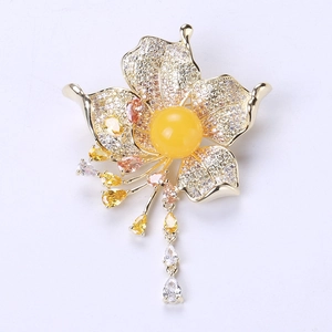 Detailed macro view of yellow floral brooch with zircon tassels and hanging crystal charms