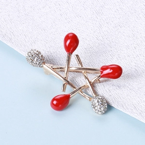 Elegant gold alloy matchstick star brooch with red enamel and sparkling rhinestones