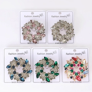 Detailed set of 5 crystal baroque brooches with colorful marquise-cut gems in macro view