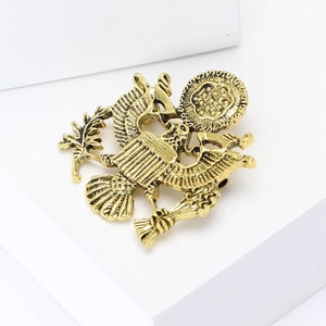 Vintage gold eagle brooch badge featuring classic emblem design for suits and coats