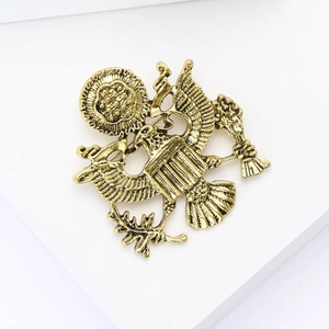 Detailed close-up of a vintage golden eagle brooch with fine embossed relief craftsmanship