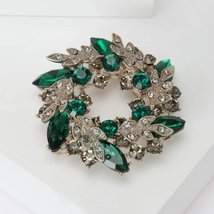 Baroque crystal wreath brooch with emerald and grey gemstones in luxury vintage design