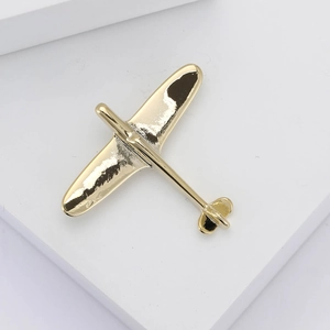 Elegant gold polished airplane brooch for suits with minimalist classic aviation design