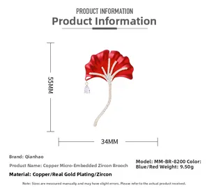 Macro detail of red ginkgo leaf brooch with zircon inlay and pear-shaped drop pendant