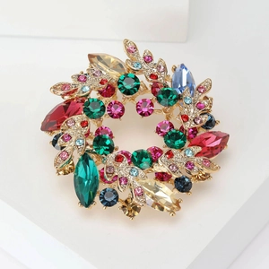 Detailed macro view of colorful baroque crystal flower brooch on a white stand