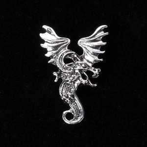 Gothic style silver dragon brooch with detailed wings and scales on a black background