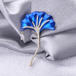 Detail of royal blue ginkgo leaf brooch with pavé zircon and pear-cut water drop pendant