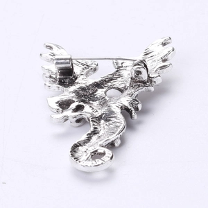 Detailed back view of vintage dragon brooch showing secure silver alloy safety pin clasp