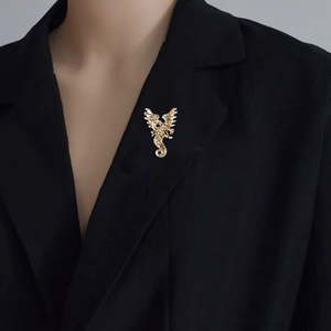 Vintage golden dragon brooch with wings pinned on a formal black suit lapel