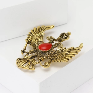 Vintage gold alloy double-headed dragon brooch with red gemstone and crown detail