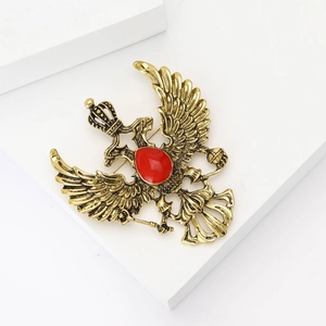 Vintage gold double-headed eagle brooch with red oval gemstone and crown details