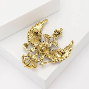 Detail of the back metal pin structure and vintage gold double-headed eagle brooch design
