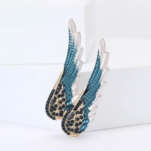 Élégante broche ailes d'ange dorée avec strass bleus dégradés sur blocs géométriques
