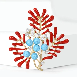 Detail of coral brooch with gold branches, turquoise beads, and red enamel accents
