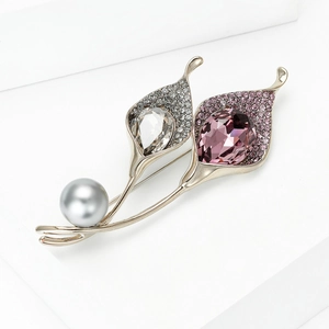 Elegant Calla Lily brooch with crystals and grey pearl on minimalist white pedestal