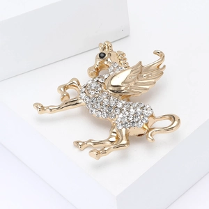 Sparkling gold Pegasus brooch with clear rhinestones and black gem eye for suits