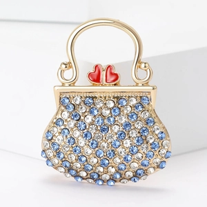 Broche luxueuse en forme de sac à main avec strass bleus et détails dorés