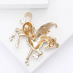 Detailed back view of gold Pegasus brooch showing secure safety pin and textured metal finish