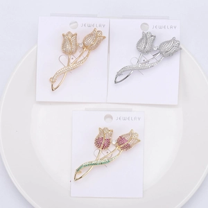 Detail view of tulip brooches in three colors with cubic zirconia on jewelry card