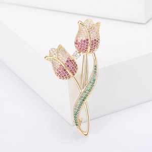 Elegant tulip brooch with colorful pavé cubic zirconia and gold plating on white stand
