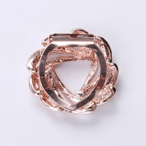 Close-up of the rose gold metal scarf buckle with a floral spiral design and a secure clip
