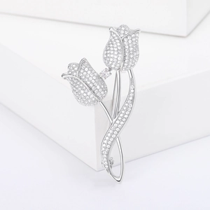 Elegant silver tulip brooch with micro-pave cubic zirconia on a minimalist stand