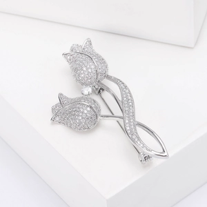 Detailed close-up of micro-paved cubic zirconia on silver tulip brooch petals