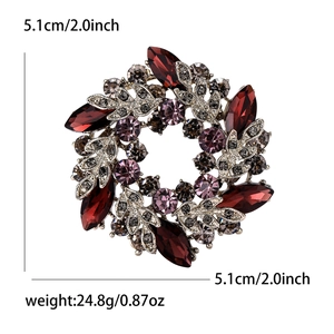 Detail of flower brooch with red marquise gems and purple crystals in silver setting