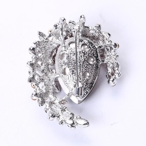 Detail view of the silver brooch back showing the secure rotating safety pin clasp
