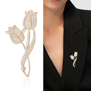 Elegant gold tulip brooch with micro-paved zircons shown in studio and on black suit
