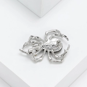 Vintage silver spider brooch for men's suits with realistic metallic texture on white stone