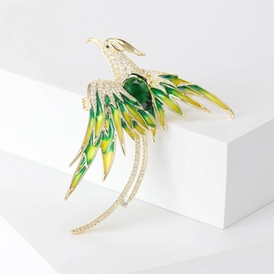 Close-up of luxury phoenix brooch with green gradient enamel and zircon inlay