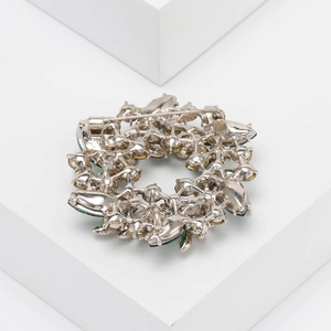 Detail view of the secure pin clasp and metal structure on the back of the flower brooch