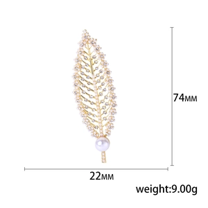 Elegant gold leaf brooch with pearls and rhinestones measuring 74mm by 22mm