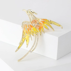 Detail of phoenix brooch with champagne gemstone, zircon inlay and enamel wings
